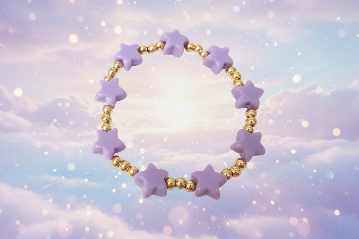 Bracelet with purple star-shaped beads and gold beads on a white background
