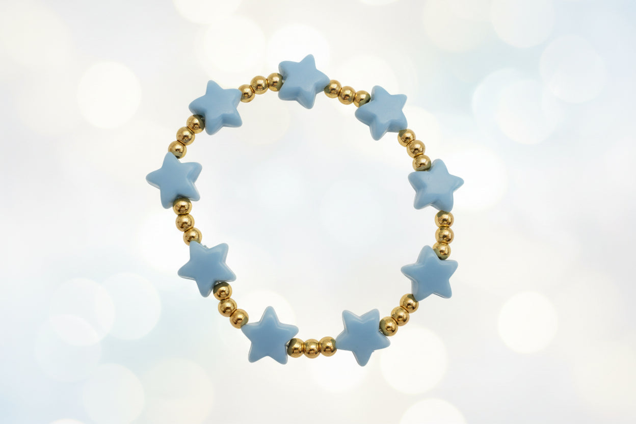 Bracelet with blue star-shaped beads and gold beads on a white background